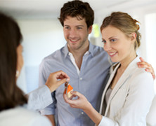 a couple getting handed the keys to their new home